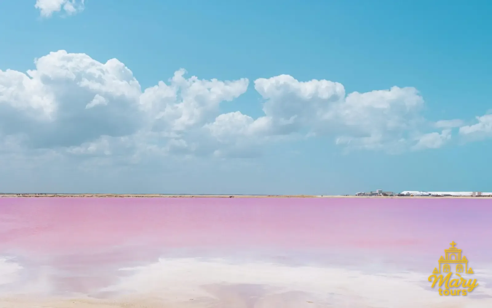 Pink lagoon at Las Coloradas beside a strip of sand