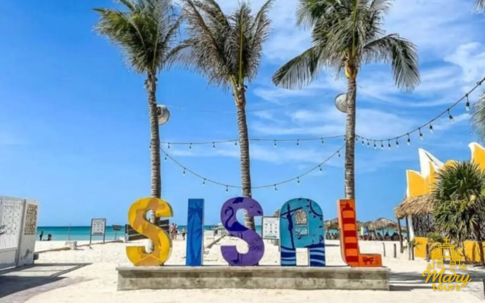 Palm trees and the Sisal sign on the Yucatán coast